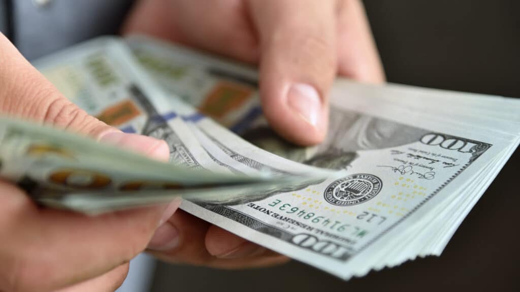 someone holding and counting money
